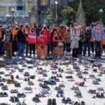People stand around shoes that honor all the missing indigenous children during the first National Day for Truth and Reconciliation, on Parliament Hill in Ottawa, Canada, on September 30, 2021. Photo: VCG.