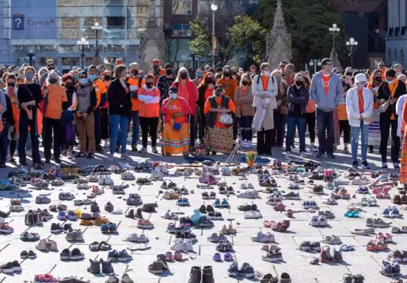 People stand around shoes that honor all the missing indigenous children during the first National Day for Truth and Reconciliation, on Parliament Hill in Ottawa, Canada, on September 30, 2021. Photo: VCG.