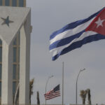 Cuban and US flags fly in the wind outside the US embassy in Havana, Cuba, Tuesday, Jan.14, 2025. Photo: Ariel Ley/AP.
