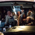 Palestinians freed from Israel’s Ofer military prison wave to the crowd from an International Committee of the Red Cross (ICRC) bus as they arrive in Beitunia, in the occupied West Bank on Monday morning. Photo: AFP.