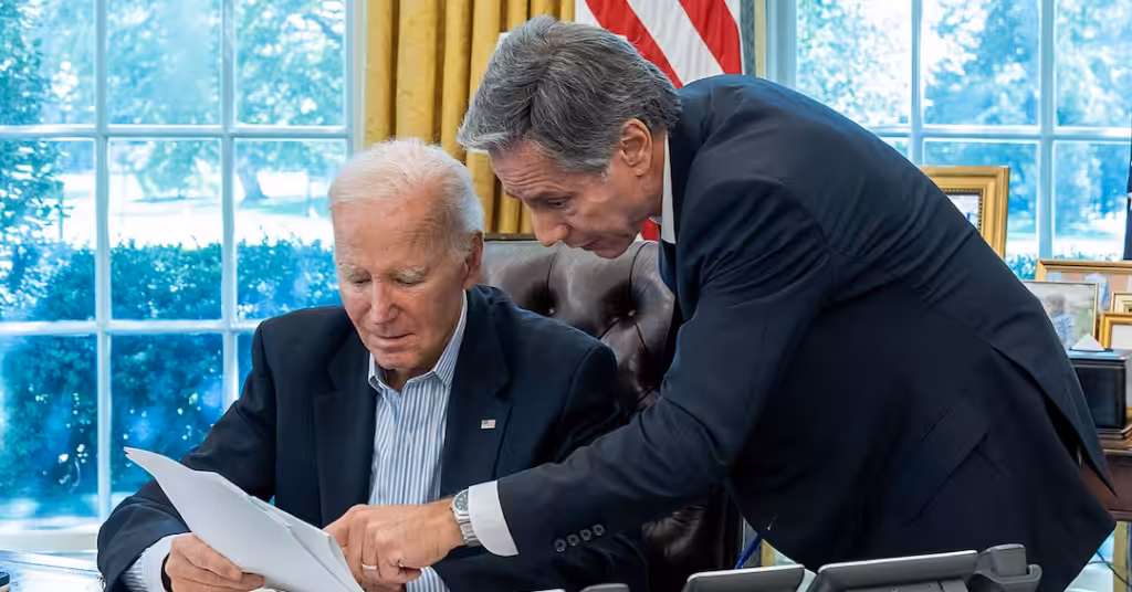 President Joe Biden, joined by Secretary of State Antony Blinken, is briefed on a resistance strike on 'Israel,' Saturday Oct. 7, 2023, in the Oval Office of the White House. Photo: Cameron Smith/White House.