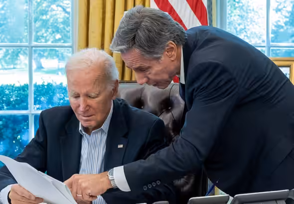 President Joe Biden, joined by Secretary of State Antony Blinken, is briefed on a resistance strike on 'Israel,' Saturday Oct. 7, 2023, in the Oval Office of the White House. Photo: Cameron Smith/White House.