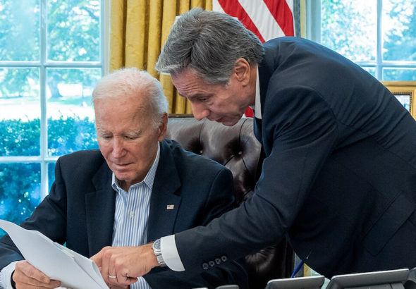 President Joe Biden, joined by Secretary of State Antony Blinken, is briefed on a resistance strike on 'Israel,' Saturday Oct. 7, 2023, in the Oval Office of the White House. Photo: Cameron Smith/White House.