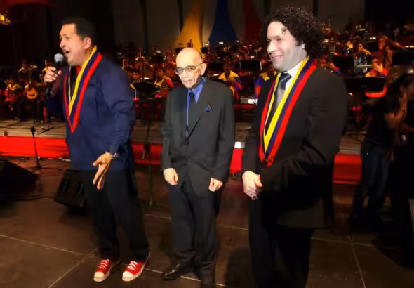 Late Venezuelan President Hugo Chávez (left), late maestro José Antonio Abreu (center), and Gustavo Dudamel (right), music director of the Simón Bolívar Symphony Orchestra and the Los Angeles Philharmonic. File photo.