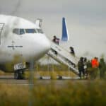 Migrants board a plane bound to southern Mexico as part of a repatriation flight to their countries, at the Piedras Negras International Airport, in Piedras Negras, Coahuila state, Mexico, December 23, 2023. Photo: Reuters/José Luis González.
