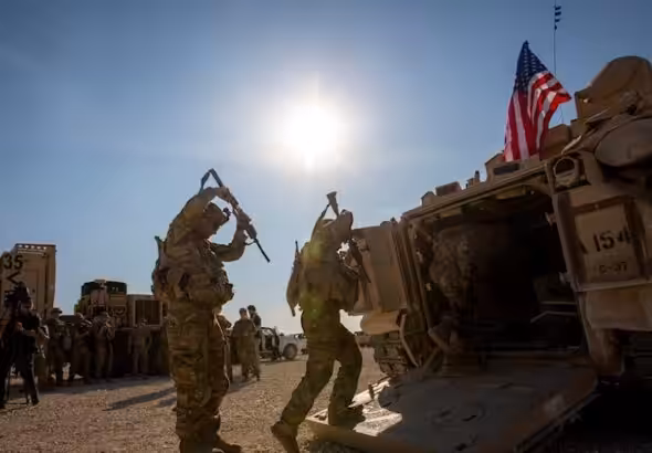 Crewmen enter Bradley fighting vehicles at a US military base at an undisclosed location in Northeastern Syria, on November 11, 2019.  Photo: AP/file photo.