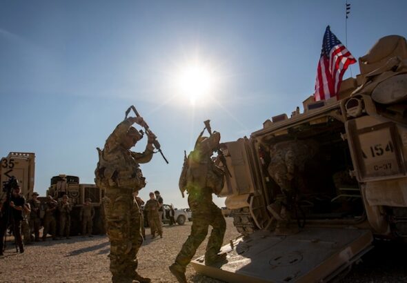 Crewmen enter Bradley fighting vehicles at a US military base at an undisclosed location in Northeastern Syria, on November 11, 2019.  Photo: AP/file photo.