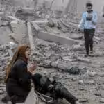 A Palestinian woman reacts as she craddles a wounded boy after Israeli bombardment in central Gaza City on March 18, 2024. Photo: AFP.