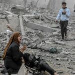 A Palestinian woman reacts as she craddles a wounded boy after Israeli bombardment in central Gaza City on March 18, 2024. Photo: AFP.