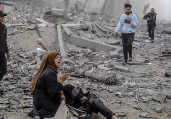 A Palestinian woman reacts as she craddles a wounded boy after Israeli bombardment in central Gaza City on March 18, 2024. Photo: AFP.