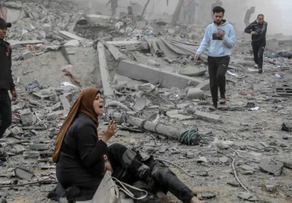 A Palestinian woman reacts as she craddles a wounded boy after Israeli bombardment in central Gaza City on March 18, 2024. Photo: AFP.