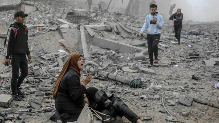 A Palestinian woman reacts as she craddles a wounded boy after Israeli bombardment in central Gaza City on March 18, 2024. Photo: AFP.