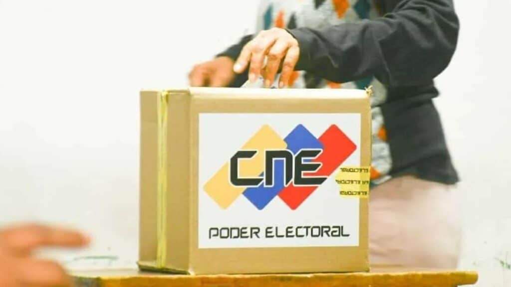 A Venezuelan voter deposits a ballot in a box at a polling center. File photo.