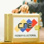 A Venezuelan voter deposits a ballot in a box at a polling center. File photo.