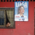 Ecuadorian presidential candidate Luisa González's electoral campaign poster hangs on a housefront. Photo: EFE.