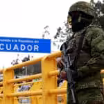 Ecuadorian heavily armed soldier patrolling a border checkpoint near a sign reading “welcome to the Republic of Ecuador.” Photo: Karen Toro/Reuters/file photo.