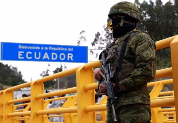 Ecuadorian heavily armed soldier patrolling a border checkpoint near a sign reading “welcome to the Republic of Ecuador.” Photo: Karen Toro/Reuters/file photo.