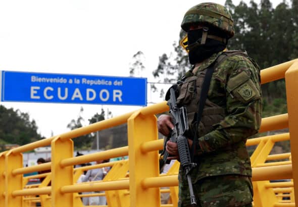 Ecuadorian heavily armed soldier patrolling a border checkpoint near a sign reading “welcome to the Republic of Ecuador.” Photo: Karen Toro/Reuters/file photo.