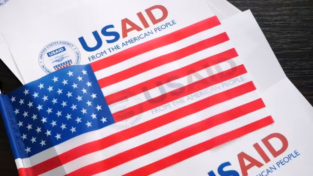 USAID logo and US flag. Photo: Kawsachun News/file photo.