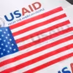 USAID logo and US flag. Photo: Kawsachun News/file photo.