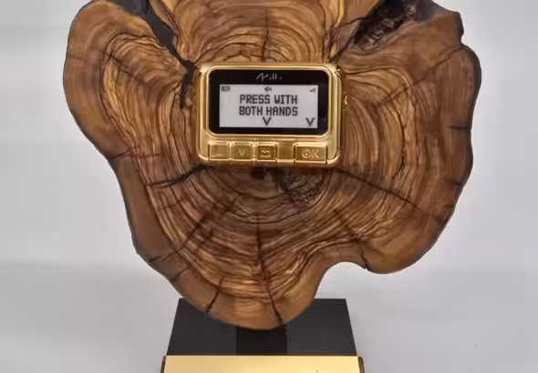 Benjamin Netanyahu's gift to Donald Trump (from one settler to another): a gaudy golden pager mounted on a slice of felled ancient olive tree; Feb 6, 2025. Photo: BBC.