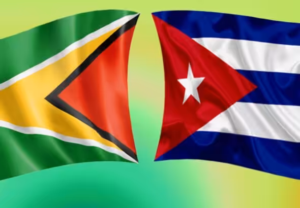 The flags of Guyana and Cuba. Photo: File photo.