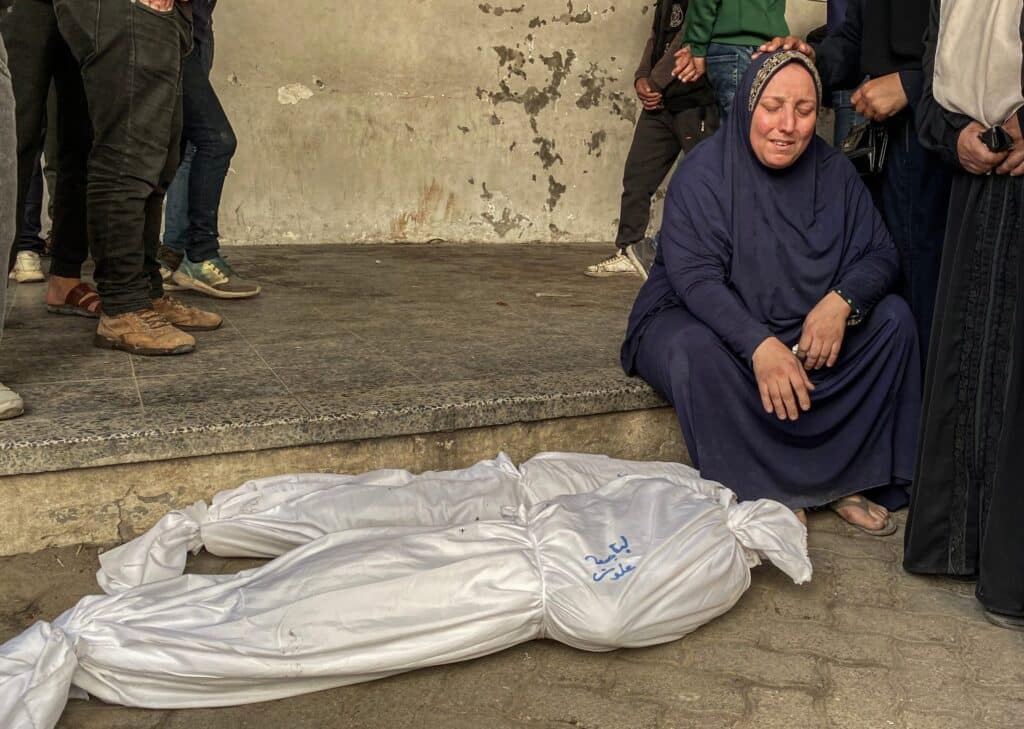 Mourners stand near the bodies of Palestinians killed in 'Israeli' strikes, ahead of a ceasefire set to take effect on Sunday (January 19), in Gaza City January 16, 2025. Photo: Hadi Daoud /Zuma Images.