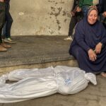 Mourners stand near the bodies of Palestinians killed in 'Israeli' strikes, ahead of a ceasefire set to take effect on Sunday (January 19), in Gaza City January 16, 2025. Photo: Hadi Daoud /Zuma Images.