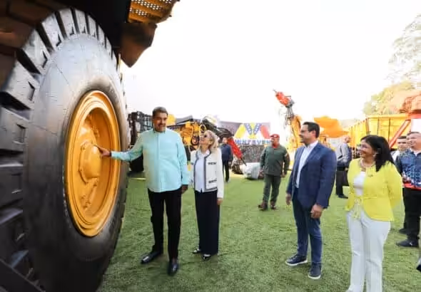 President Maduro stands in front of a massive tire. Photo: Venezuela Presidential Press.