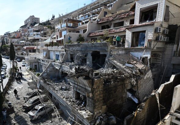 Syrian White Helmets rescuers check the site of an Israeli air strike on a building in Damascus in an area where Palestinian leaders are known to reside, on Mar. 13, 2025. Photo: AFP.