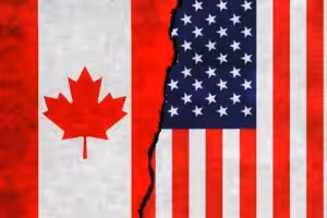 Illustration of flags of Canada and US on a cracked wall. File photo.