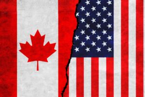 Illustration of flags of Canada and US on a cracked wall. File photo.