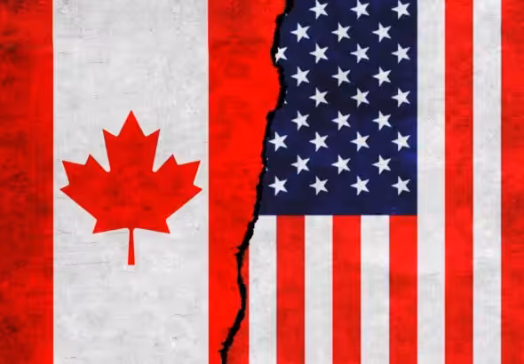 Illustration of flags of Canada and US on a cracked wall. File photo.