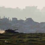 A tank manoeuvres inside Gaza, as seen from the Israeli settler colony's border with Gaza, March 19, 2025. Photo: Amir Cohen/Reuters.