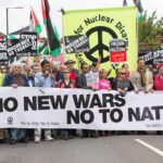 Anti-war marchers in London hold banners and posters saying "No to NATO," March 2022. Photo: CND.