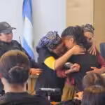 Young Mapuche woman Victoria Núñez Fernández embraces family members in court after being sentenced to two months of preventive detention for alleged arson. Photo: X/@monschlotthauer.