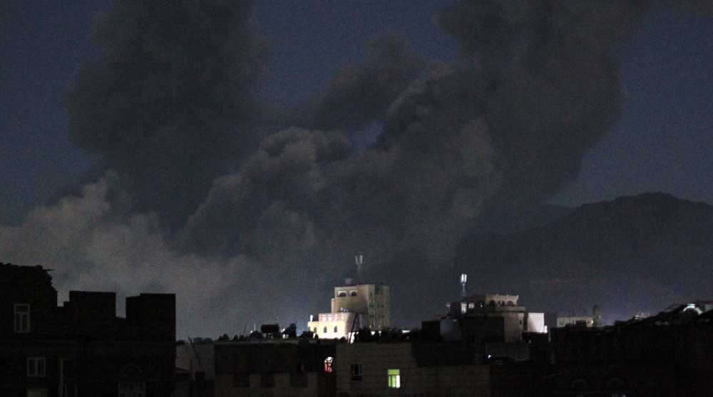 A plume of smoke billows over Sana'a, capital of Yemen, following US-British airstrikes, March 15, 2025. Photo: AFP.