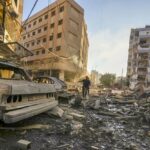 Damaged buildings and vehicles following an Israeli airstrike in southern Beirut, on Oct. 4.Photographer: Photo: Hassan Ammar/AP Photo.
