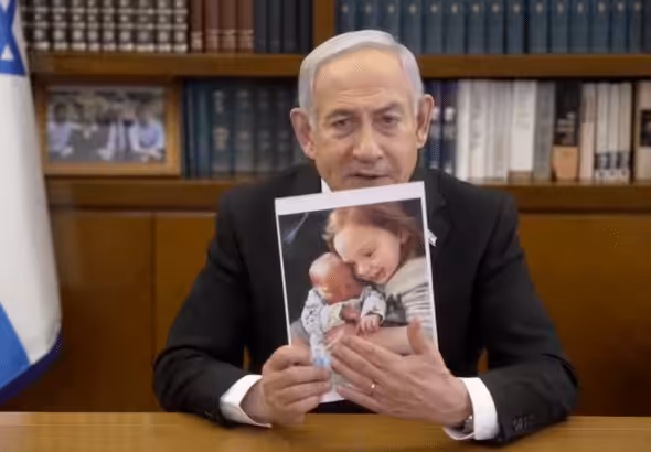Benjamin Netanyahu with a photograph. Photo: Caitlin Johnstone/File photo.