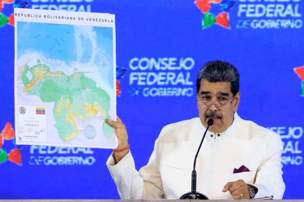 President Maduro holds a map of the Bolivarian Republic of Venezuela, showing the Essequibo as part of the country, at a press conference. Photo: AFP.