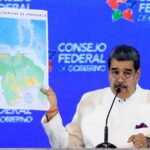 President Maduro holds a map of the Bolivarian Republic of Venezuela, showing the Essequibo as part of the country, at a press conference. Photo: AFP.
