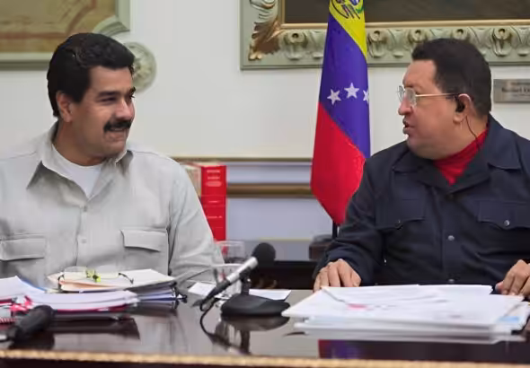 Then-Venezuelan Vice President Nicolás Maduro smiling next to President Hugo Chávez during a televised meeting at Miraflores Palace, Caracas, in 2013, a few weeks before Hugo Chávez's passing. Photo: Presidential Press.