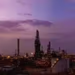An oil refinery stretches into the purple horizon. Photo: Chevron.