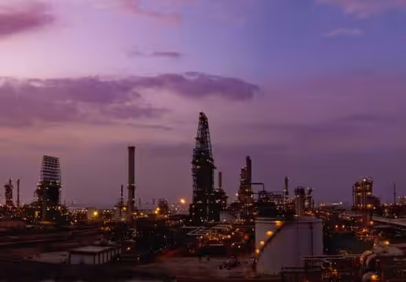 An oil refinery stretches into the purple horizon. Photo: Chevron.