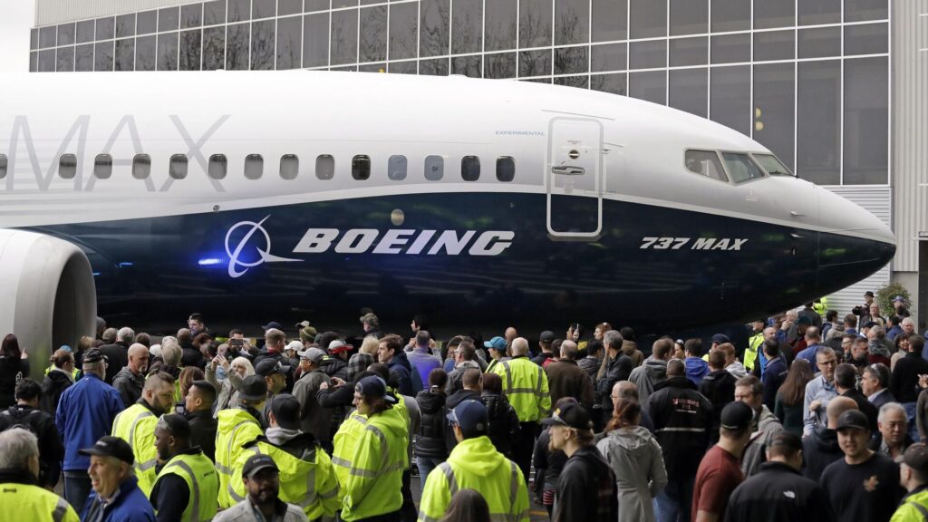Boeing employees surround the 737 MAX, the MAX 7, after it rolled out last year in Renton. Boeing hired thousands of workers in Washington state and companywide in 2018. Photo: Elaine Thompson/AP Photo.