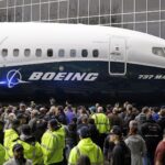 Boeing employees surround the 737 MAX, the MAX 7, after it rolled out last year in Renton. Boeing hired thousands of workers in Washington state and companywide in 2018. Photo: Elaine Thompson/AP Photo.