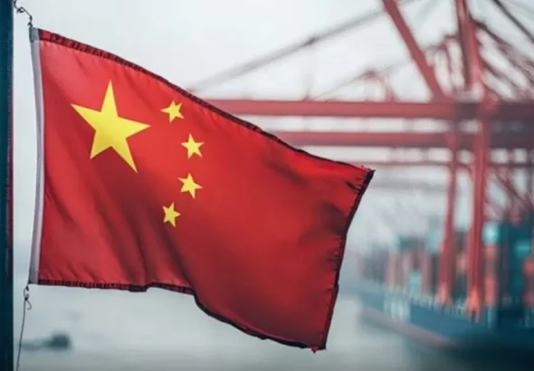 Chinese flag with ships and machinery in the background. Photo: X/@nii_gma.