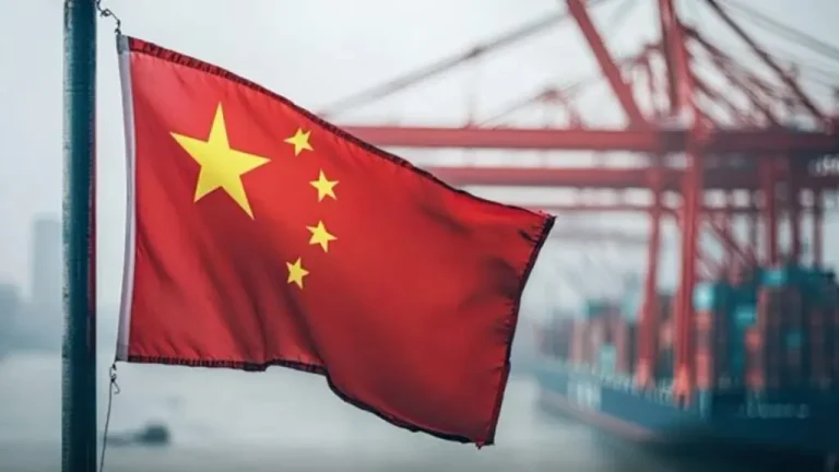 Chinese flag with ships and machinery in the background. Photo: X/@nii_gma.