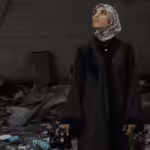 Fatima Hassouna standing amid rubble. Photo: Fatima Hassouna.