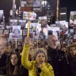 'Israeli' protesters hold signs and photos of captives during a rally calling for their release in Tel Aviv on February 3, 2015. Photo: Getty Images.